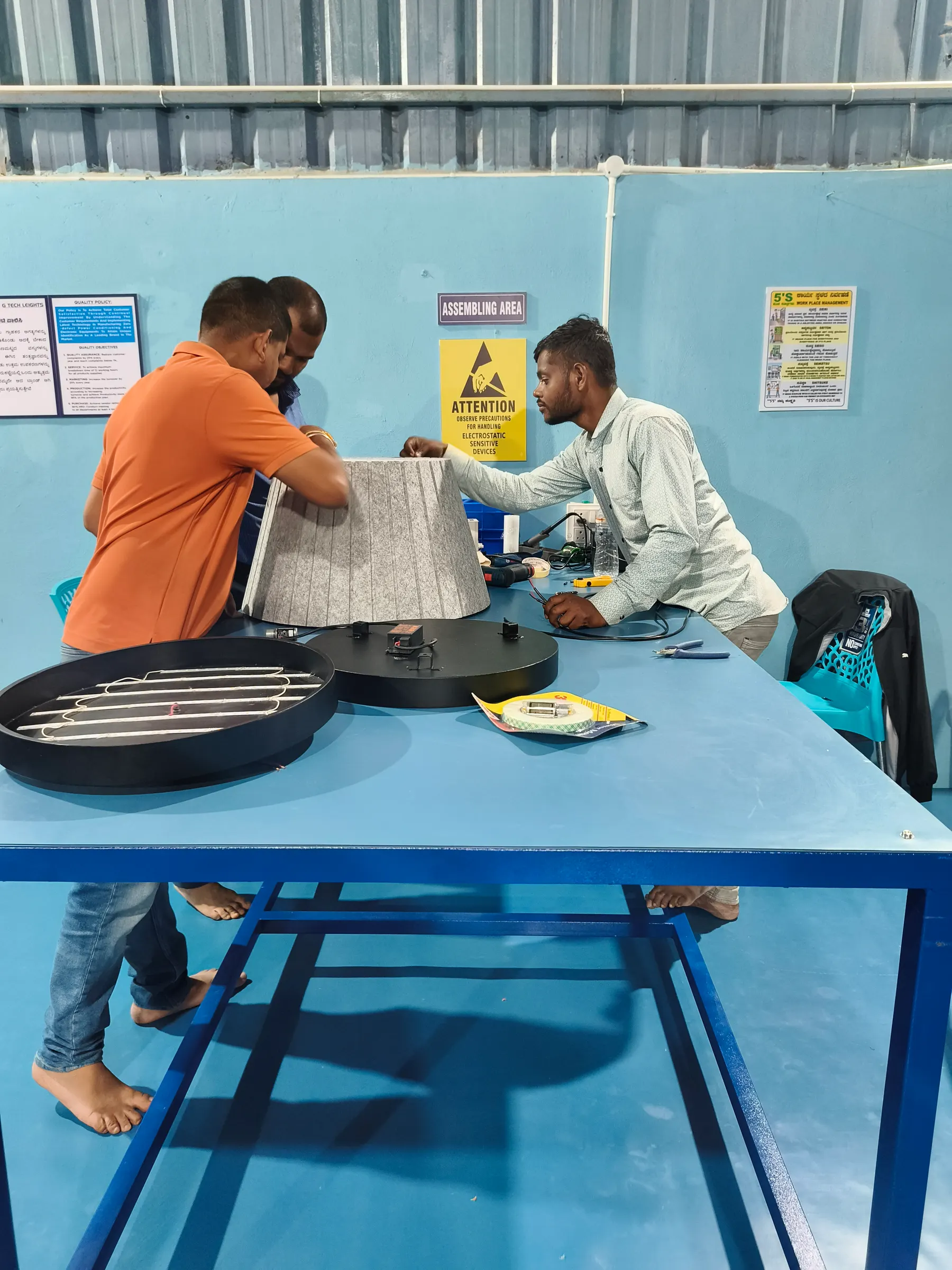 Technicians assembling a pendant in the assembling area
