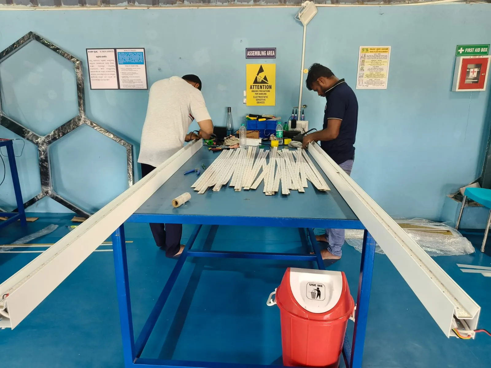 Technicians assembling linear LED luminaires at the G Tech Lights assembling bench