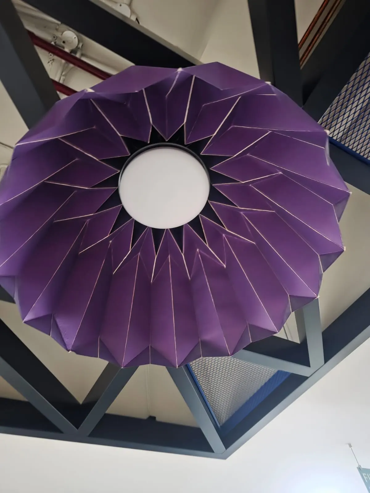 Purple folded origami-style pendant seen from below